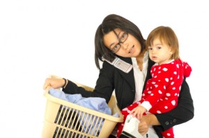 Woman Mutitasking with Baby, Laundry, Phone and Iron