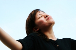 Woman Taking Deep Breath Woman smiling with good health